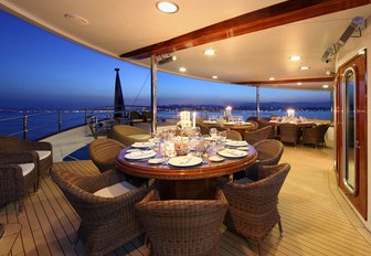 circular dining tables on main deck aft aboard charter yacht SHERAKHAN 