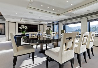 dining table in the light and airy main salon of charter yacht LILI