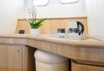 Charter yacht IRENE bureau with stool and plant