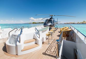 sundeck of my seanna with spa pool and helicopter in background