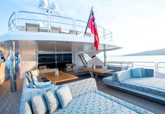 large sun pads and alfresco dining on main deck aft of motor yacht BLUSH 