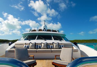 Portuguese bridge with seating and sun pads on board charter yacht Sweet Escape 