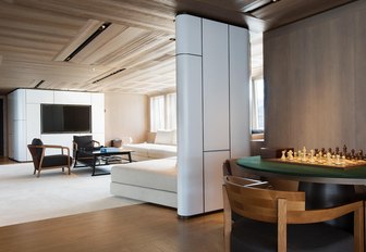 the stylish and minimalist main salon of charter yacht cloudbreaker where guests can relax and look out towards the caribbean sunset 