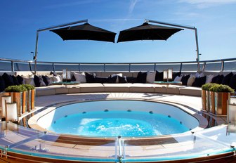 inviting Jacuzzi surrounded by sunpads on the sundeck of luxury yacht SEALYON