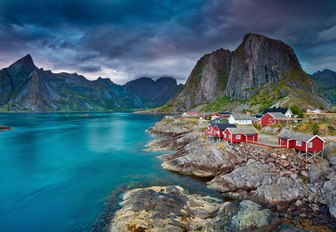 sun sets behind a village in the Lofoten Islands, Norway