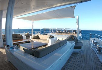 spacious aft deck area with seating aboard charter yacht SIREN