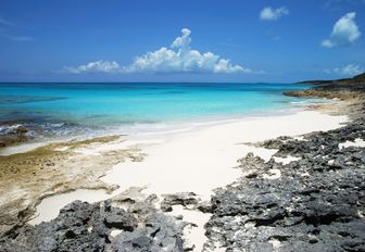 white sand deserted beach in the Bahamas with turquoise sea