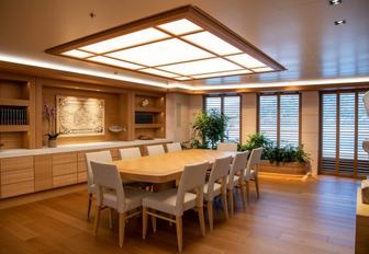 An interior dining table with chairs onboard superyacht charter FLYING FOX