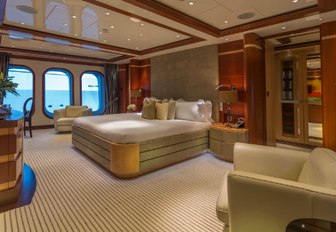 master suite with full-length windows and large bed on board motor yacht Sequel P