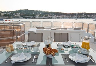 breakfast is served on the sundeck's alfresco dining table on board charter yacht ‘African Queen’ 