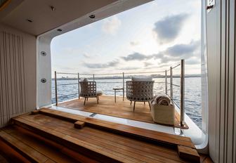 Superyacht charter SYMMETRY fold-down balcony with chairs