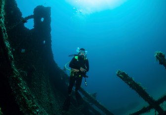 Scuba divers examine a shipwreck in Greece