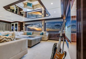 cinema area with vintage guitar in skylounge of charter yacht ‘King Baby’ 