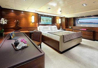 owners suite on sailing yacht prana, with bed in middle and spacious dressing table