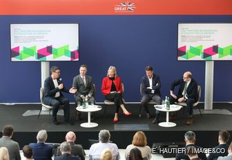 Panel of speakers on stage at MIPIM