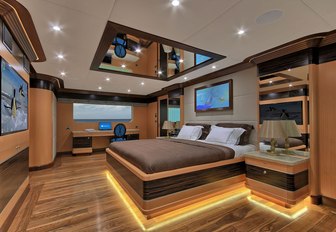 large bed in the wood-clad master suite on board charter yacht MEIRA