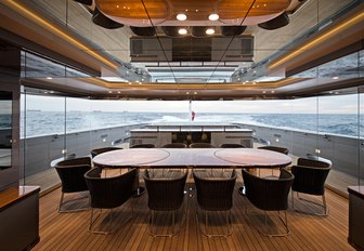 An oak dining table situated on the exterior of superyacht 'Silver Fast'