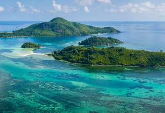 Green jungle islands in the Seychelles, with blue sea surrounding