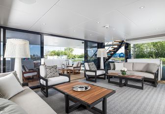 A sliding glass door dividing the interior and exterior sections of superyacht IRISHA