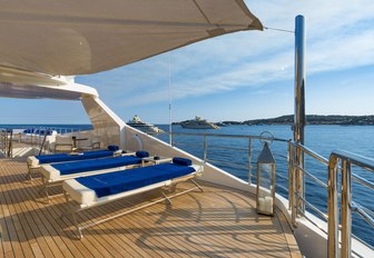 Trio of massage tables on exterior deck facing the sea onboard M/Y SERENITY