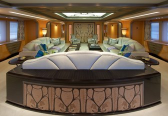 The light blue and green seating found in the main salon of superyacht AMARYLLIS