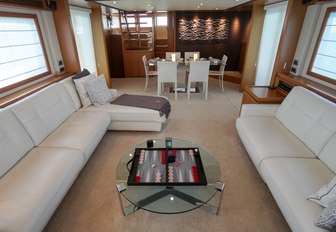 spacious and comfortable seating area inside the salon of charter yacht NOMADA