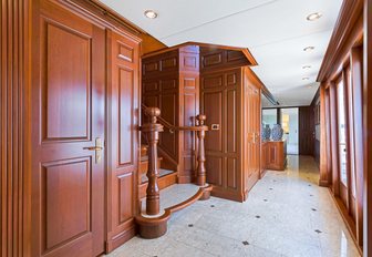 marble floored hallway with wooden wall panels on board motor yacht PRAXIS 