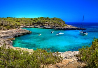 Secluded cove with yachts and blue sky