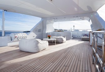 spacious and chic sundeck with multiple lounging areas aboard charter yacht GO