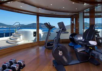 Overview of the gym onboard superyacht charter ALFA NERO with large full height windows