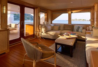 bamboo-clad walls and deep sofas in the skylounge of charter yacht ANCALLIA 