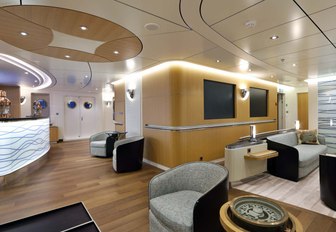 superyacht yersin main salon, with seating area and backlit bar