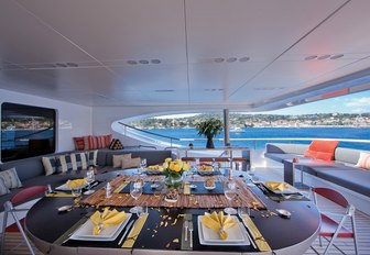 Alfresco dining set up on upper deck of motor yacht Sai Ram