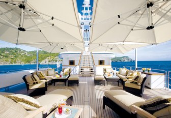 seating area shaded by umbrellas on the split-level sundeck of motor yacht UTOPIA