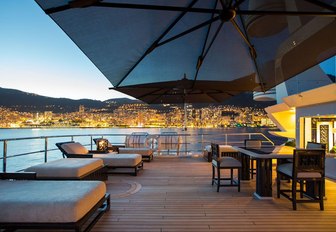 the upper aft deck of motor yacht lioness v with luxuriour sun loungers and mini alfresco dining area