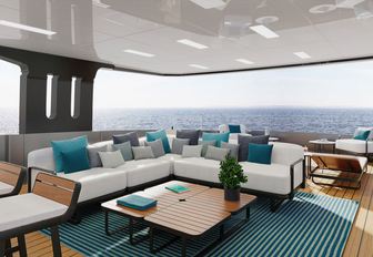 Charter yacht LOEWE exterior seating area with white sofa and teal cushions