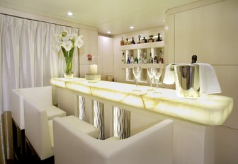 backlit onyx bar in main salon aboard luxury yacht ROMA