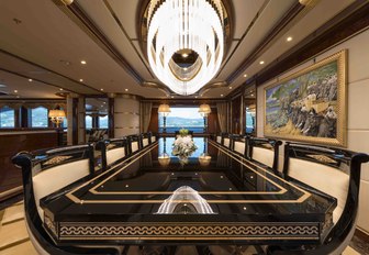 Black dining table in main salon of luxury yacht Mine Games