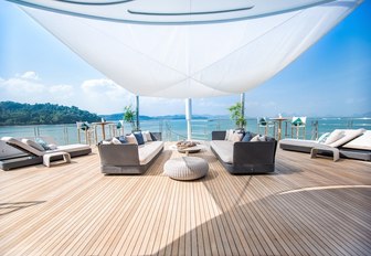 sofas and sunloungers under a canopy shade on board motor yacht SALUZI