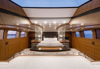 large bed in teak-clad master suite on board luxury yacht ‘Silver Fast’ 