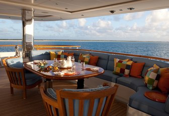 colourful upholstery and table in aft deck lounging area aboard charter yacht OASIS 