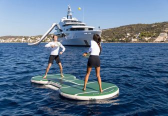 Charter yacht LUDZIE and two guests on a small floating pickleball court