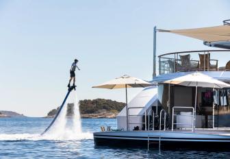 Charter yacht LUDZIE with guest on a flyboard