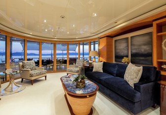 navy blue sofa and armchairs in an upper deck salon aboard charter yacht Lucky Lady 