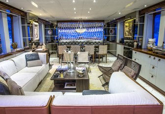 seating area and formal dining setup in the main salon aboard charter yacht Zulu