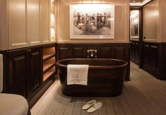 free-standing walnut bathtub in the master suite of charter yacht SATORI