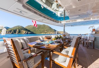 al fresco dining setup on the aft deck of motor yacht King Baby 