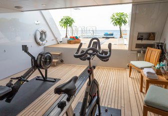 gym equipment in the beach club of charter yacht GLADIATOR with views out onto the swim platform