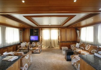 Main salon with comfortable sofas and TV on motor yacht DARDENELLA