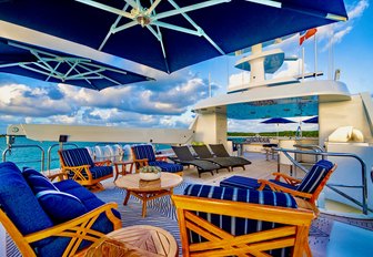 Charter yacht AQUASITION sun deck with loungers and armchairs
